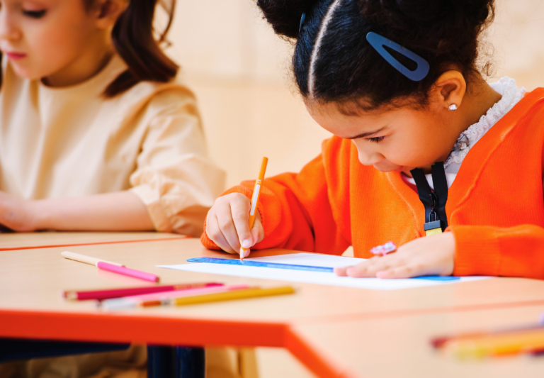 little girl writing on paper